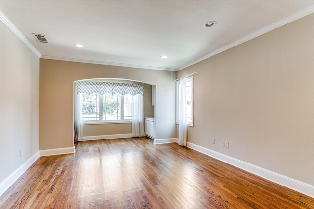 unfurnished room featuring light hardwood / wood-style flooring and ornamental molding