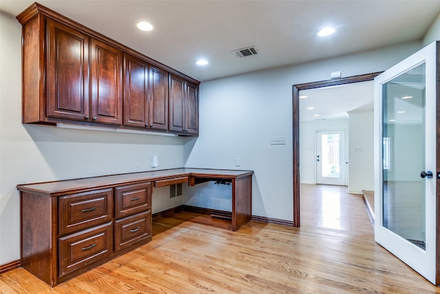 office area featuring built in desk and light hardwood / wood-style floors