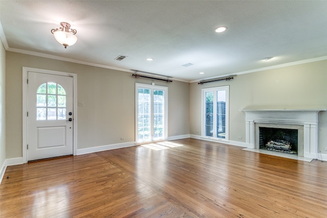 interior space with light wood-type flooring and crown molding