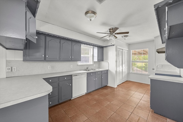 kitchen featuring gray cabinets, sink, light tile patterned floors, white dishwasher, and ceiling fan