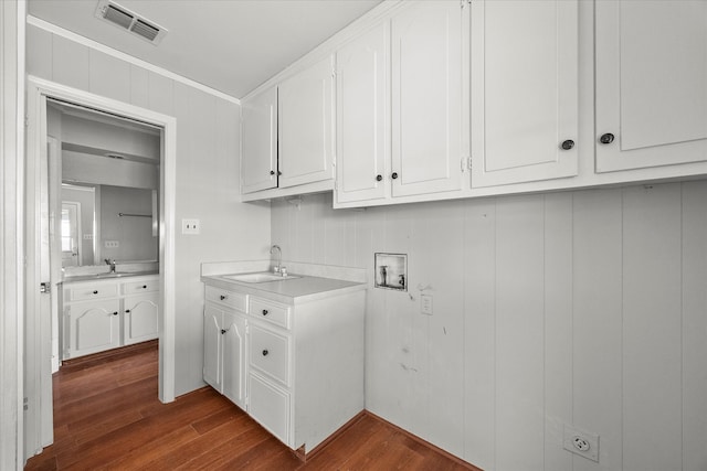 laundry area with ornamental molding, dark hardwood / wood-style floors, washer hookup, and sink