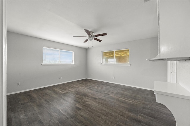 unfurnished living room with ceiling fan and dark hardwood / wood-style floors