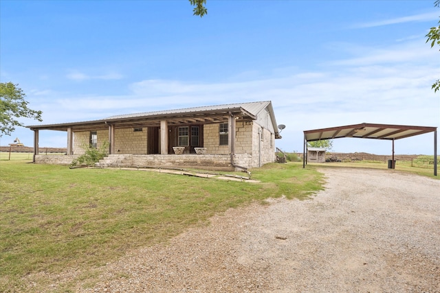 view of front facade with a carport, covered porch, and a front yard