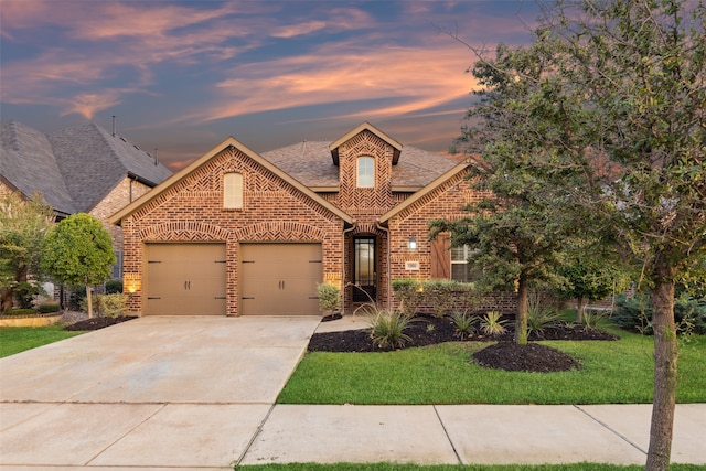 view of front facade with a lawn and a garage