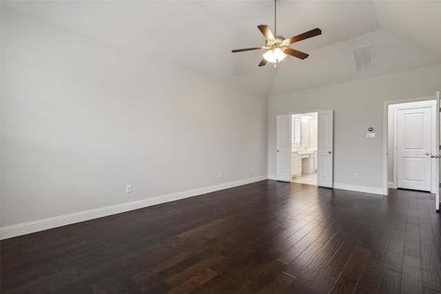 unfurnished bedroom featuring ensuite bath, lofted ceiling, ceiling fan, and dark wood-type flooring