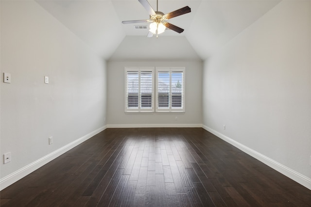 unfurnished room featuring vaulted ceiling, dark hardwood / wood-style floors, and ceiling fan