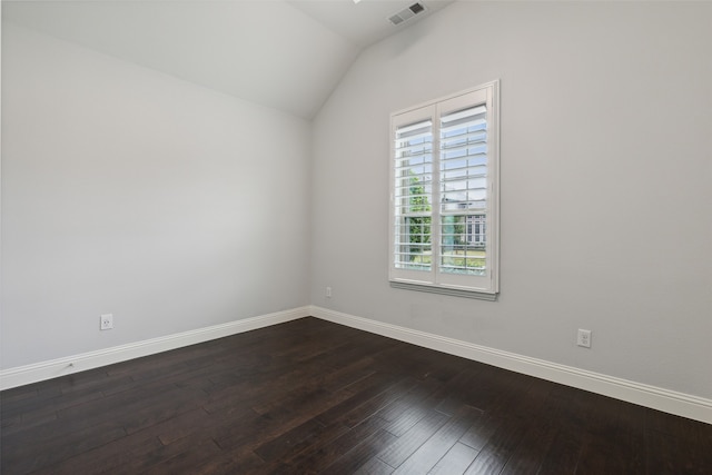 unfurnished room with lofted ceiling, dark wood-type flooring, and a wealth of natural light