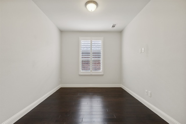 unfurnished room featuring dark wood-type flooring