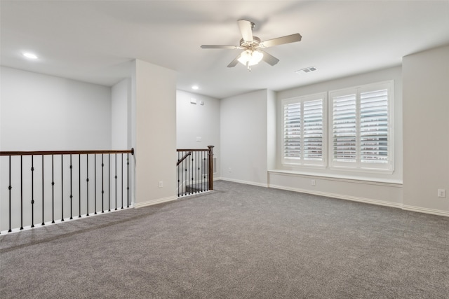 carpeted spare room with ceiling fan