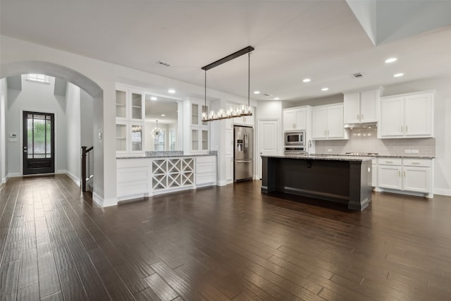 kitchen with white cabinetry, dark hardwood / wood-style floors, and stainless steel appliances