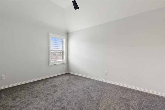 carpeted empty room featuring ceiling fan and vaulted ceiling