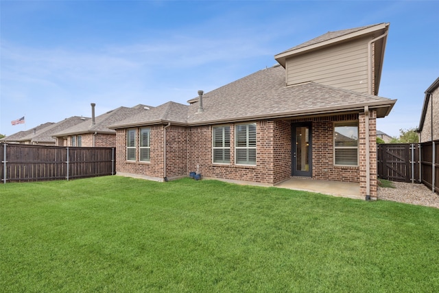 rear view of house featuring a lawn and a patio area