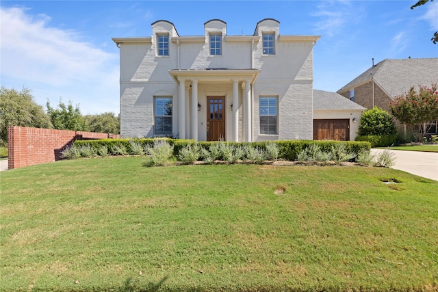 view of front of house with a garage and a front lawn