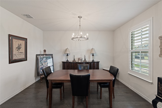 dining room featuring dark wood-type flooring and a notable chandelier