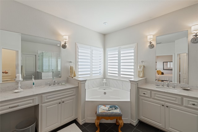 bathroom featuring tile patterned flooring, vanity, and a tub