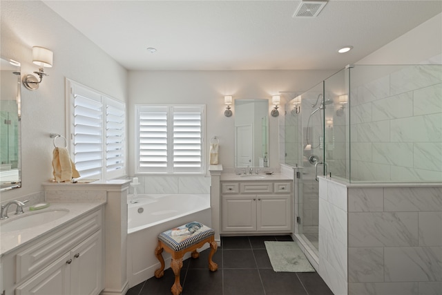 bathroom featuring vanity, tile patterned flooring, and separate shower and tub