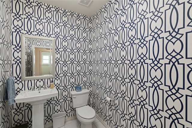 bathroom with sink, tile patterned floors, and toilet