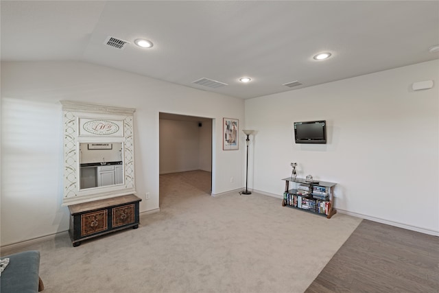 living room with vaulted ceiling and carpet floors