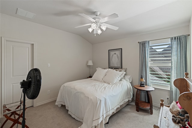 bedroom with multiple windows, ceiling fan, light colored carpet, and vaulted ceiling