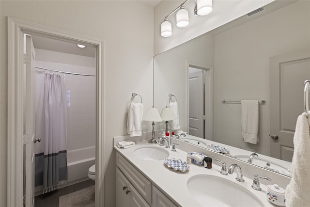 full bathroom with vanity, toilet, and shower / bathtub combination with curtain