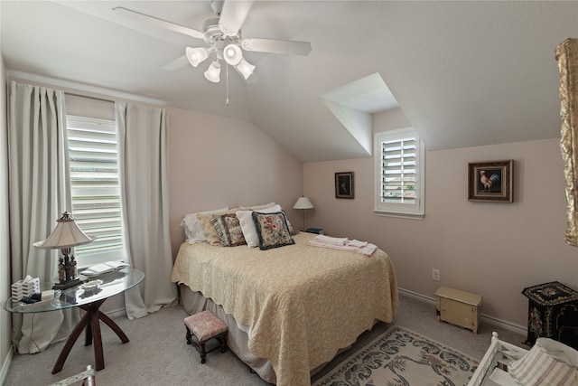 carpeted bedroom featuring ceiling fan, vaulted ceiling, and multiple windows