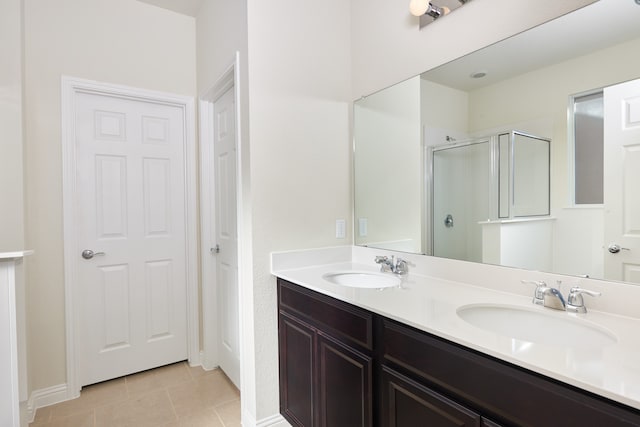 bathroom featuring walk in shower, vanity, and tile patterned floors