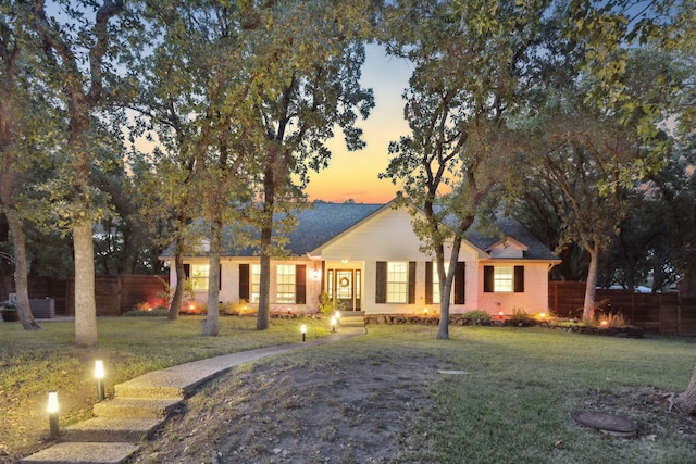 ranch-style home featuring a yard