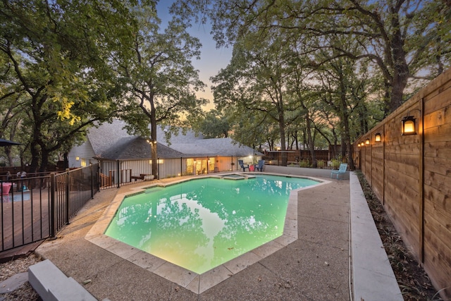 view of pool at dusk