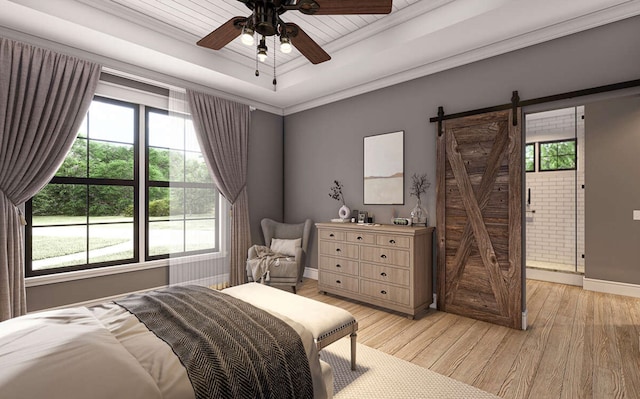 bedroom with a barn door, light hardwood / wood-style floors, ceiling fan, and multiple windows