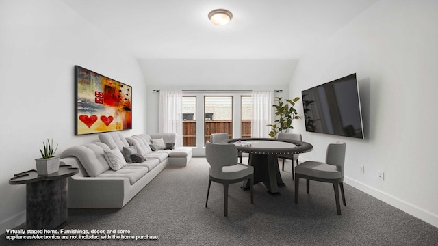 living room featuring carpet floors, baseboards, and vaulted ceiling