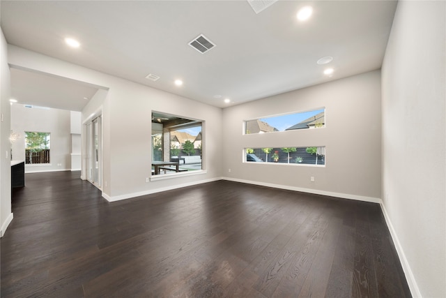 unfurnished living room with dark hardwood / wood-style flooring