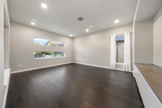 spare room featuring dark hardwood / wood-style floors