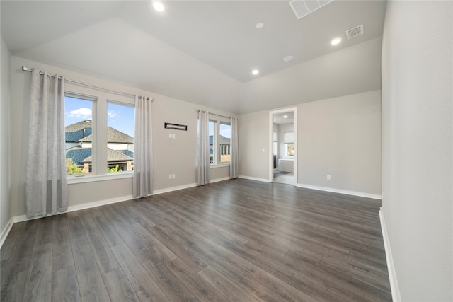 empty room featuring dark hardwood / wood-style floors and lofted ceiling