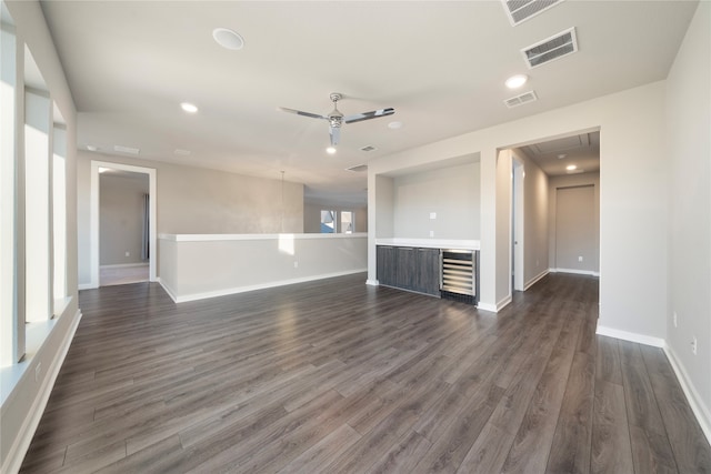 spare room with ceiling fan and dark hardwood / wood-style flooring