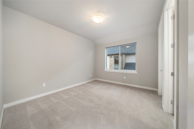 unfurnished room featuring light colored carpet