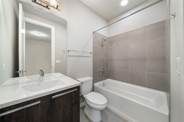 full bathroom featuring tile patterned floors, vanity, toilet, and tiled shower / bath