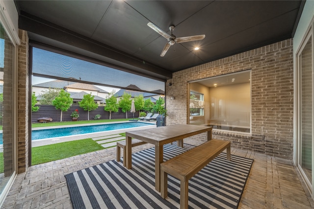 view of patio / terrace with a fenced in pool and ceiling fan