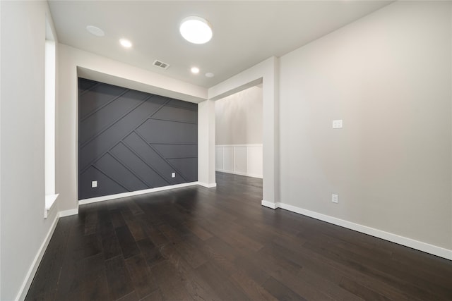 spare room with dark hardwood / wood-style flooring