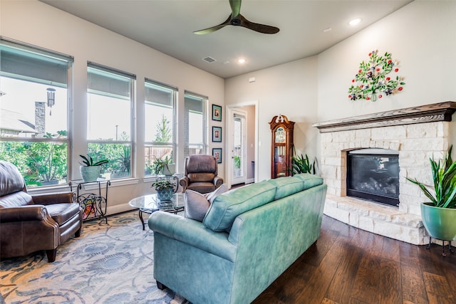 living room with hardwood / wood-style floors, a fireplace, and ceiling fan