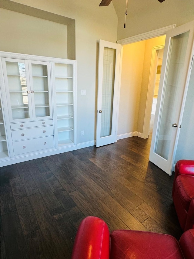 bedroom featuring lofted ceiling, french doors, dark wood finished floors, and baseboards