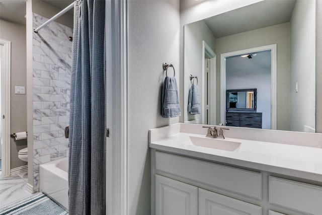 bathroom featuring shower / bath combo, marble finish floor, vanity, and toilet