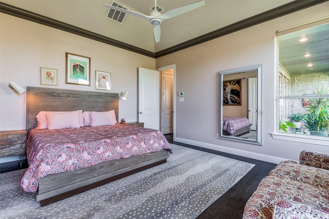 bedroom featuring dark wood-style floors, baseboards, visible vents, and ornamental molding