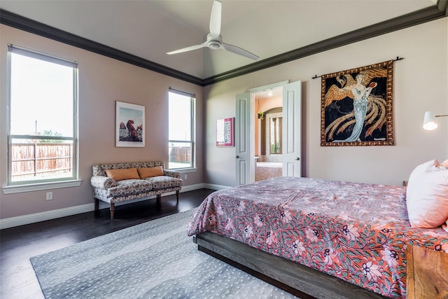 bedroom featuring ceiling fan, dark wood-style flooring, baseboards, ensuite bath, and crown molding