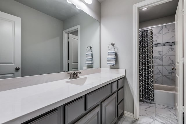 bathroom with marble finish floor, baseboards, shower / tub combo with curtain, and vanity