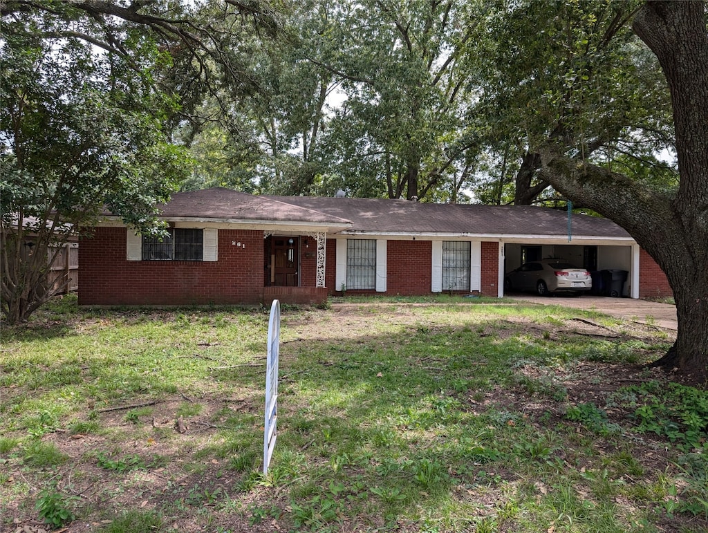 ranch-style home featuring a carport and a front yard