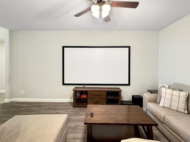 home theater featuring hardwood / wood-style floors and ceiling fan