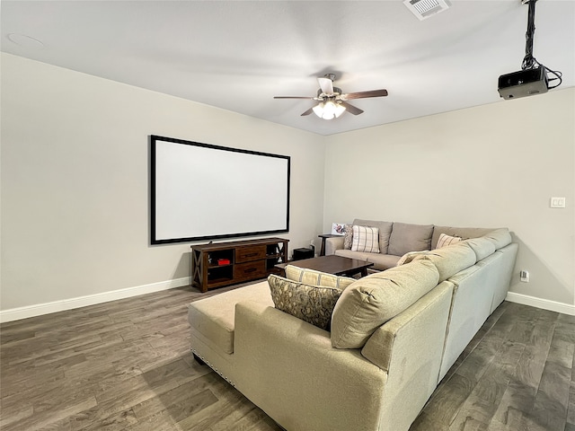 cinema with ceiling fan and dark hardwood / wood-style flooring