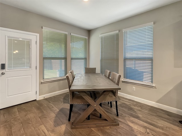 dining area with dark hardwood / wood-style flooring