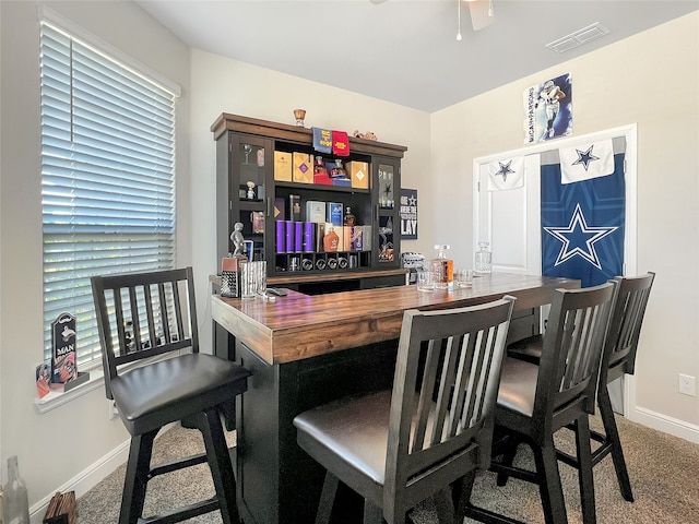 bar with carpet flooring, butcher block counters, and ceiling fan