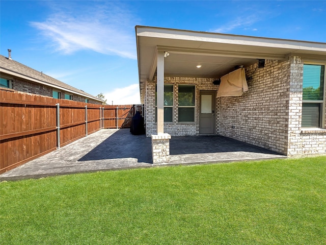 rear view of house featuring a patio and a lawn